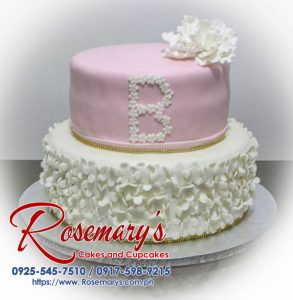 Delicious two-tier pink and white cake adorned with delicate flowers. Perfect for birthdays or celebrations! Order yours from Rosemary's Cakes: 0925-545-7510.