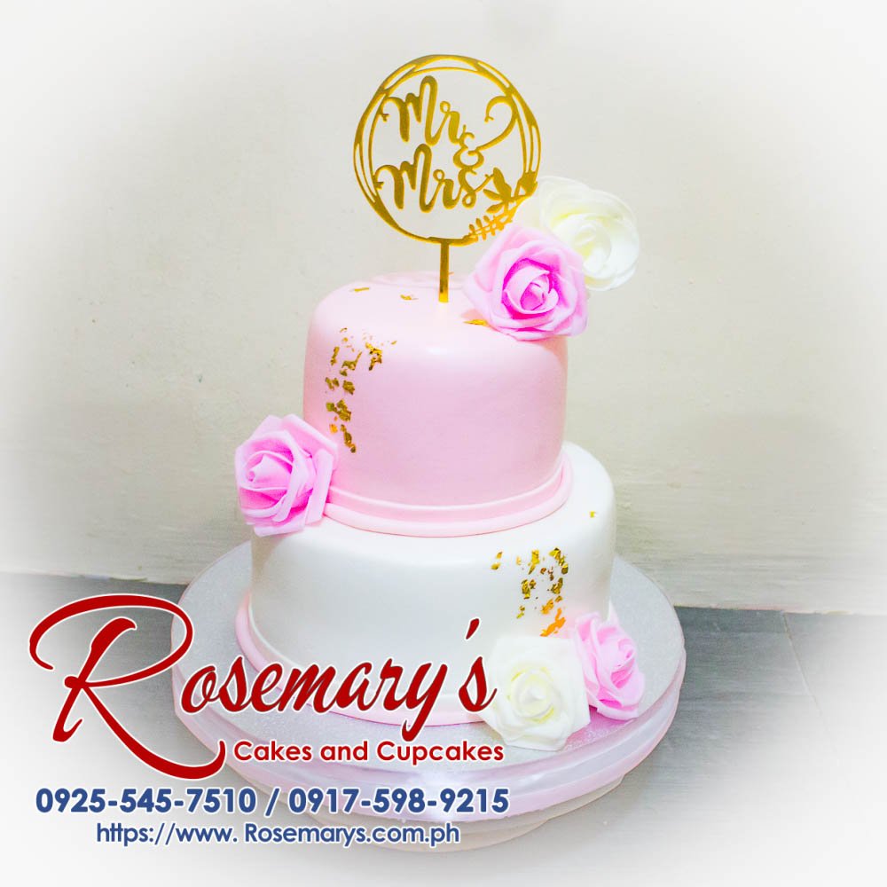 2 Layer Pink and White Mr and Mrs Wedding Cake Elegant 2 layer pink and white wedding cake decorated with delicate floral accents. Order from Rosemary's Cakes, 0925-545-7510.