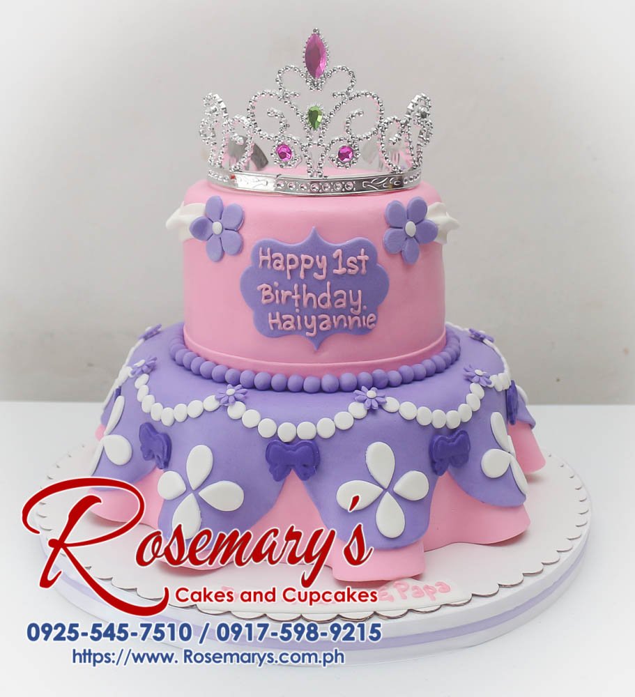 Two-tiered pink and purple princess-themed cake with delicate frosting details. Order your custom cake from Rosemary's Cakes: 0917-598-9215.