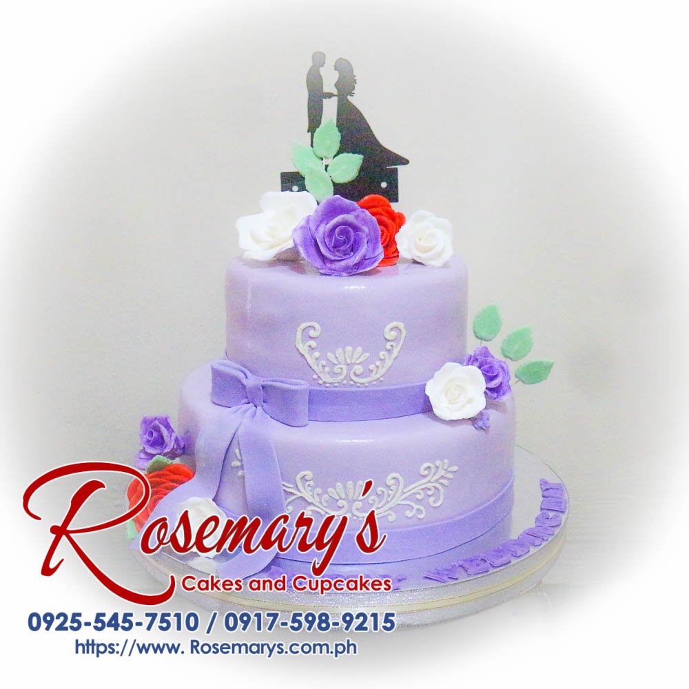 2 Layer Purple Wedding Cake Delicious 2 layer purple wedding cake with elegant floral decorations. Order now from Rosemary's Cakes at 0925-545-7510.