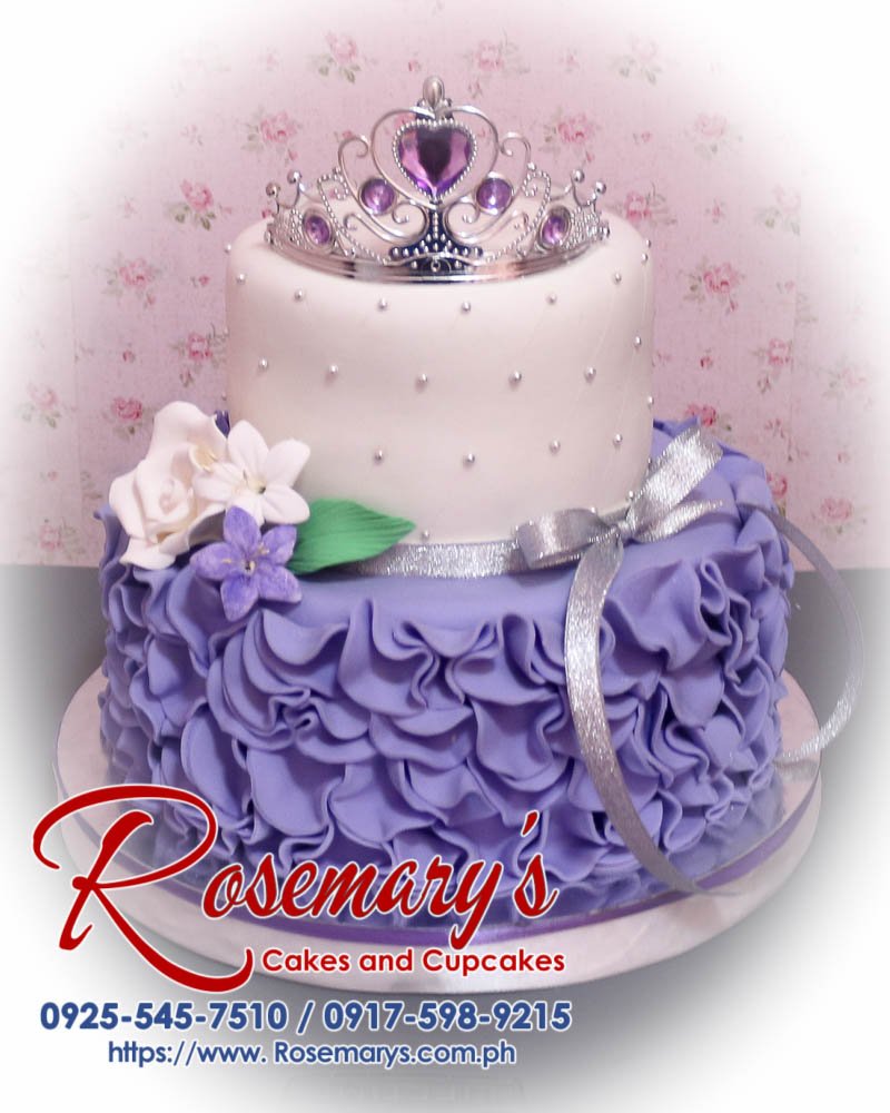 2 Layer Purple and White Princess Themed Cake Delicious 2 layer purple and white princess themed cake with a crown, perfect for celebrations. From Rosemary's Cakes, 0925-545-7510.