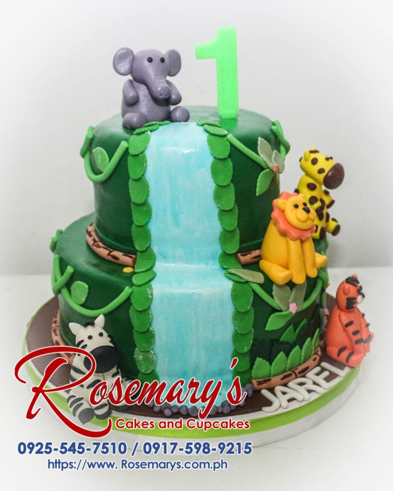 Delicious 2-tier chocolate cake with vibrant green frosting adorned with adorable fondant animal toppers, perfect for a safari-themed celebration. Rosemary's Cakes | 0925-545-7510
