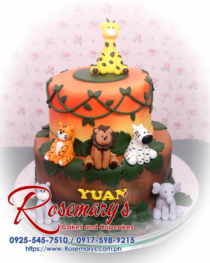 2 layer safari themed cake with vibrant orange and brown frosting, adorned with cute animal figurines. Delicious cake by Rosemary's Cakes. 0925-545-7510.