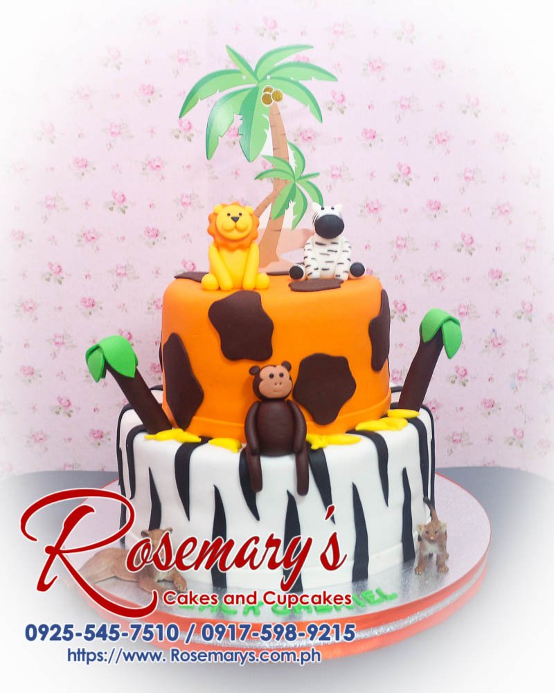 2 Layer Safari Themed Cake for Zack Gabriel Delicious 2 layer safari themed cake from Rosemary's Cakes, featuring fondant lion, monkey, and zebra on a white and orange design. Contact 0917-598-9215.