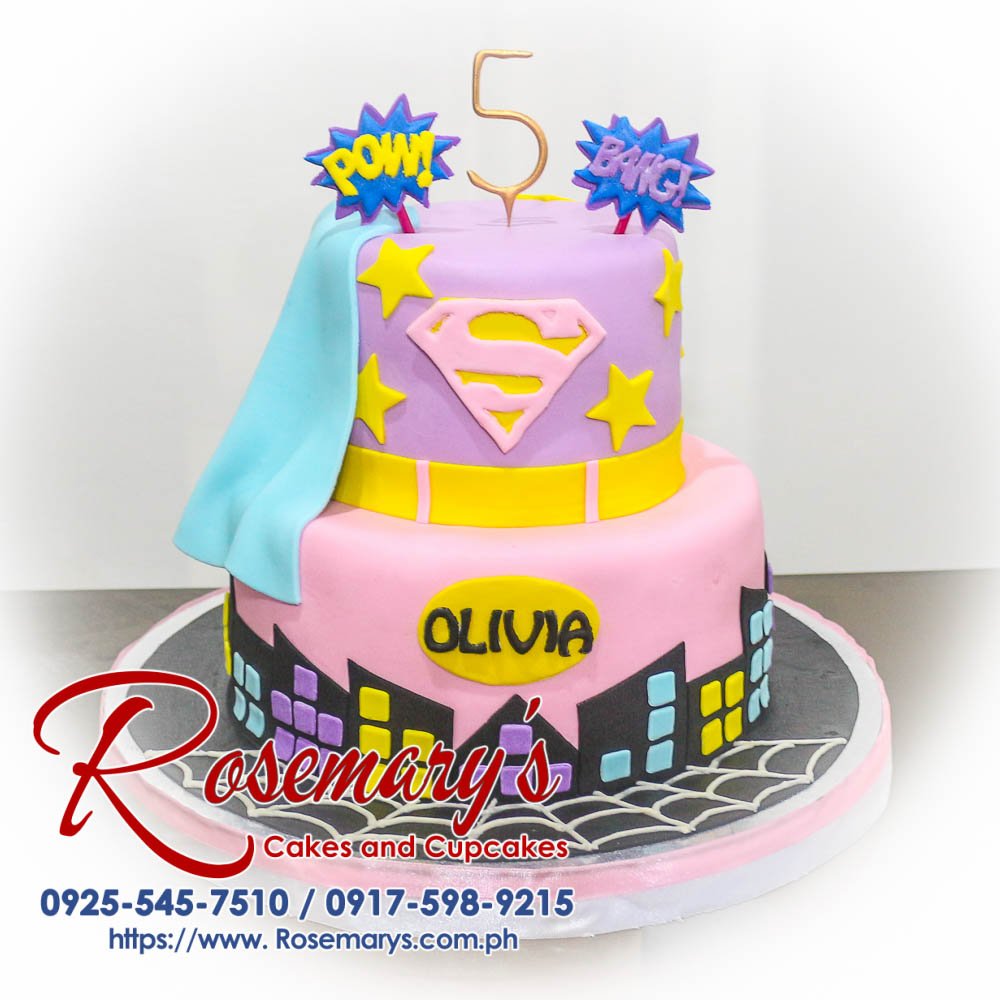Two-layer pink Supergirl themed cake with intricate frosting details. Delicious and perfect for birthdays! Rosemary's Cakes | 0925-545-7510