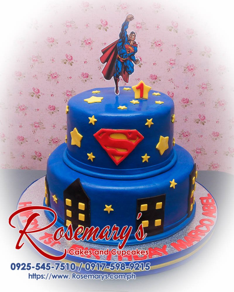 Delicious 2 layer Superman themed cake in vibrant blue, crafted by Rosemary's Cakes. Contact: 0917-598-9215.