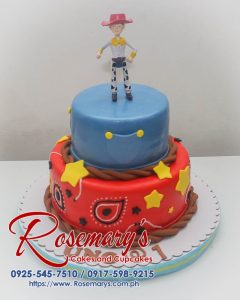 Delicious two-tier Toy Story themed cake with blue and red frosting, featuring a cowboy figurine. Made by Rosemary's Cakes. Call 0925-545-7510!