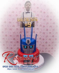 Delicious 2 layer Transformers themed cake with blue and red design, featuring Optimus Prime. Order from Rosemary's Cakes: 0925-545-7510.