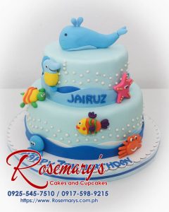 Two-tier blue cake adorned with fondant sea creatures. Perfect for ocean lovers! Order your custom creation from Rosemary's Cakes: 0917-598-9215.