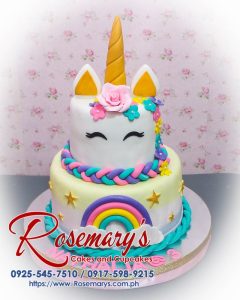 Delicious 2 layer unicorn cake in pastel pink and gold, featuring a vibrant rainbow, by Rosemary's Cakes. Contact: 0917-598-9215.