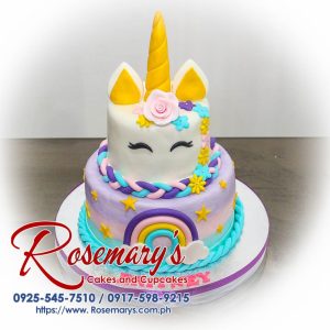 Two-layer pastel rainbow cake decorated with a whimsical unicorn horn and edible glitter. Order your dream cake from Rosemary's Cakes! Call 0917-598-9215.
