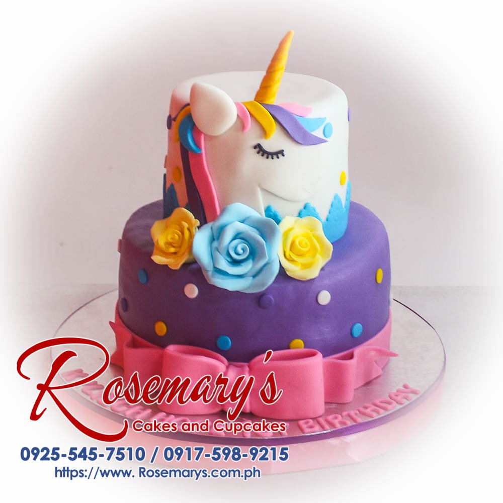 Delicious two-layer pink and purple unicorn themed cake adorned with a ribbon. Order your custom cake from Rosemary's Cakes: 0917-598-9215.