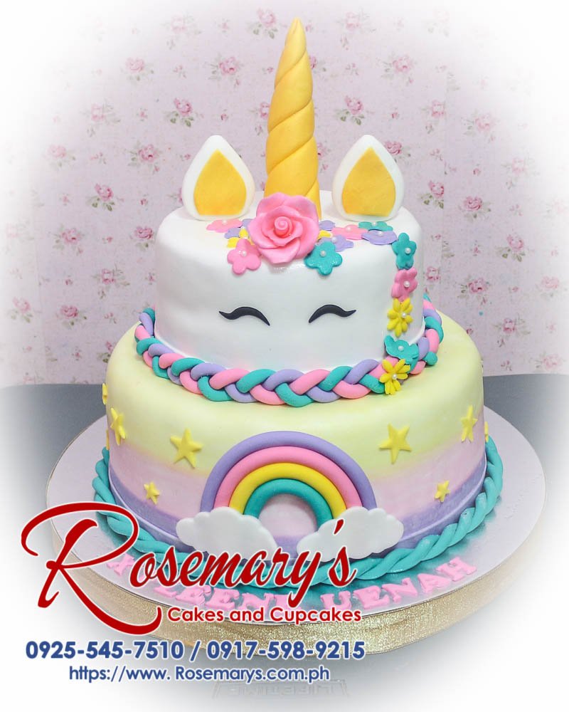 Delicious 2 layer unicorn themed cake by Rosemary's Cakes, featuring pastel pink, gold, and rainbow colors. Contact: 0917-598-9215.