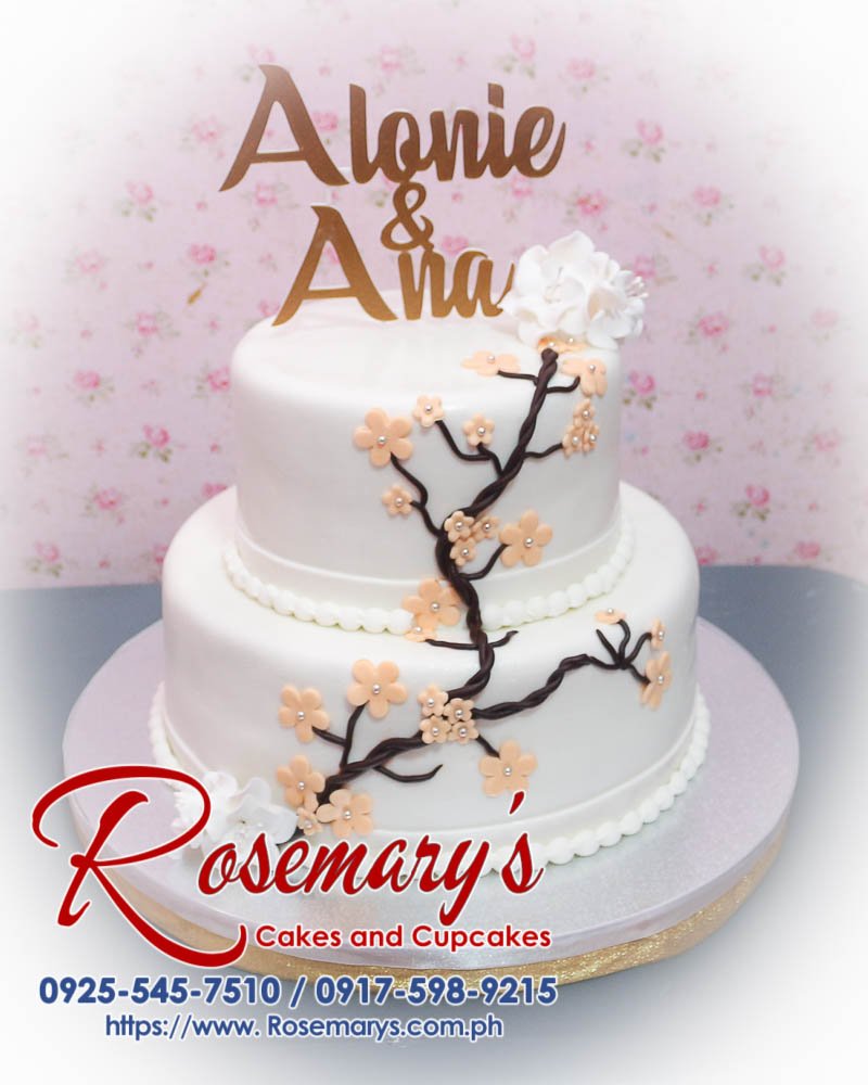 2 Layer Wedding Cake for Alonie and Ana Elegant 2-layer wedding cake with golden accents, 3D printed topper, and delicious white layers. Order from Rosemary's Cakes at 0917-598-9215.