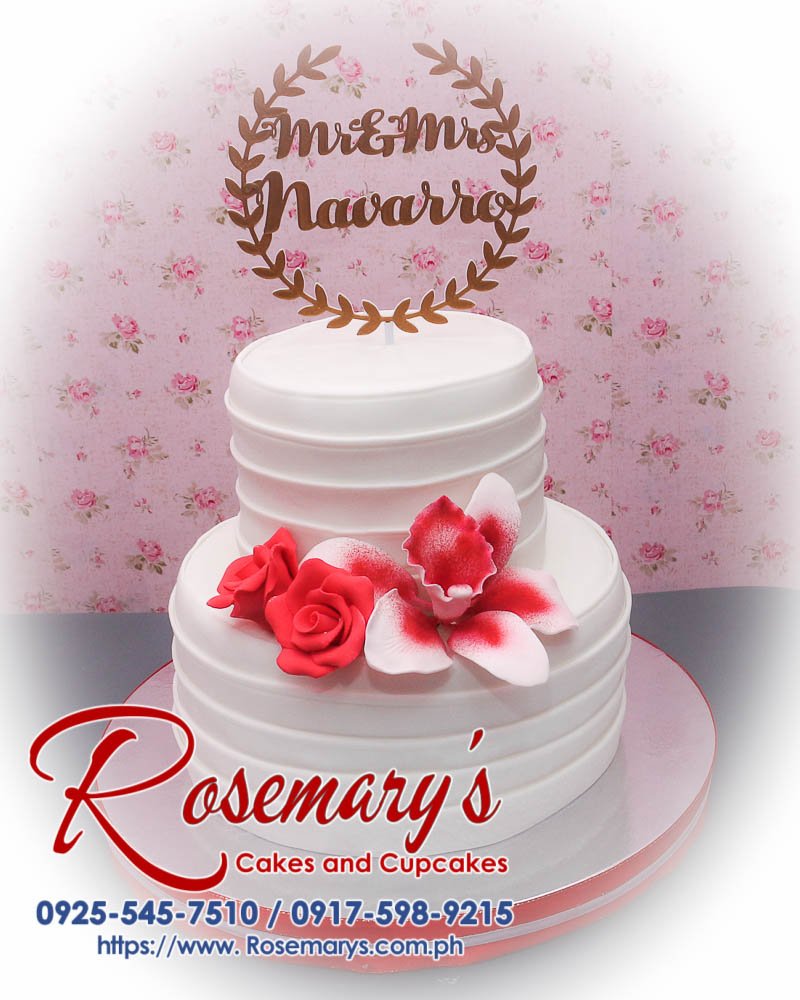 Delicious 2 layer wedding cake with a themed white design, featuring a 3D printed topper. Order from Rosemary's Cakes: 0917-598-9215.