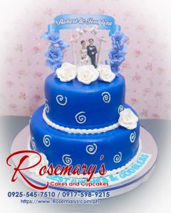 Elegant 2 layer blue wedding cake adorned with delicate decorations, perfect for any celebration. Order from Rosemary's Cakes at 0917-598-9215.