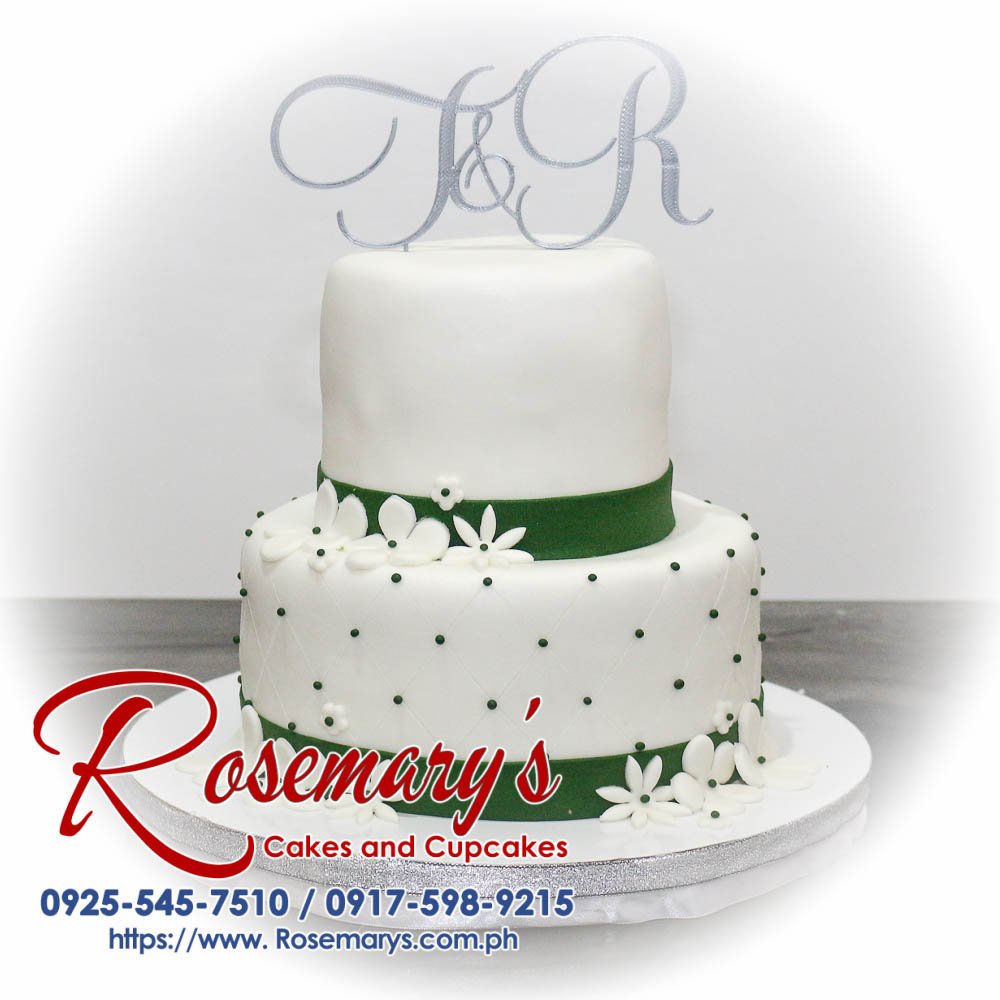2 Layer Wedding Cake with Custom 3D Printed Topper Two-layer white wedding cake adorned with a custom 3D printed topper and elegant green accents. From Rosemary's Cakes, 0925-545-7510.