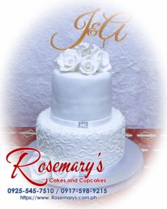 Elegant 2-layer wedding cake adorned with a custom 3D printed topper, featuring white frosting. Contact Rosemary's Cakes at 0917-598-9215.