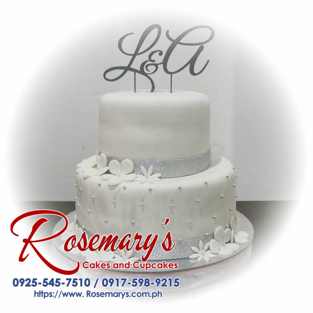 Elegant 2 layer white and silver wedding cake with custom 3D printed L&A topper from Rosemary's Cakes. Contact: 0925-545-7510.