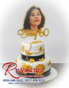 Elegant two-tier black and gold cake with white accents. Perfect for special occasions. Order yours from Rosemary's Cakes: 0917-598-9215.