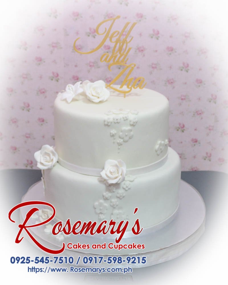 Elegant 2-layer white wedding cake featuring a custom 3D printed topper, perfect for any celebration. From Rosemary's Cakes, call 0917-598-9215.