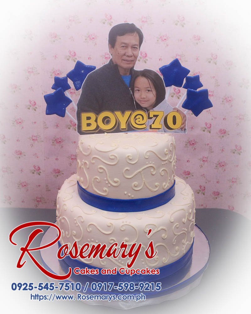 Delicious 2 layer white and blue themed cake with stars, perfect for a boy's 70th birthday. From Rosemary's Cakes, call 0925-545-7510.