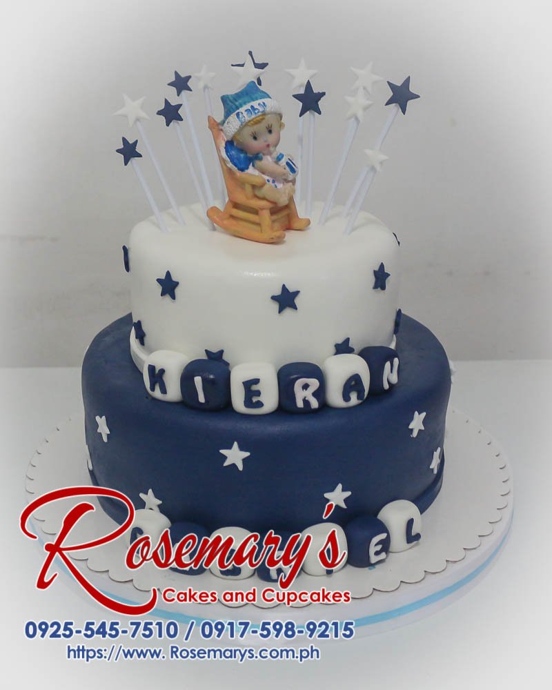 Two-tier white and blue cake adorned with delicate decorations. Perfect for baptisms and christenings. Order yours from Rosemary's Cakes: 0925-545-7510.