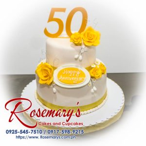 Elegant two-layer white and gold anniversary cake with intricate 3D printed details. Order your custom celebration cake from Rosemary's Cakes: 0925-545-7510.