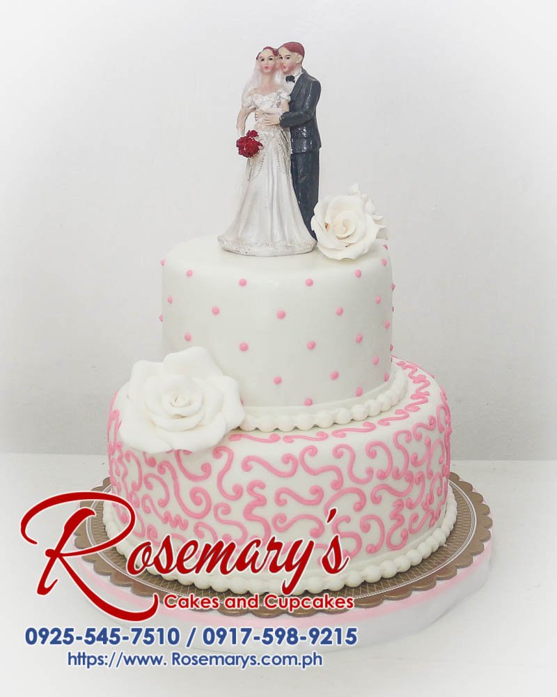 Delicious two-tier white and pink wedding cake with delicate floral decorations. Order your dream cake from Rosemary's Cakes! 0917-598-9215