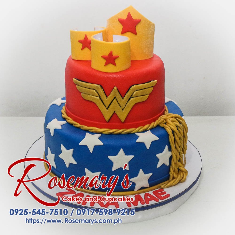 Delicious 2-tier blue and red Wonder Woman cake with gold accents. Perfect for birthdays! Rosemary's Cakes: 0917-598-9215