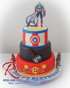 Three-layer Avengers-themed cake with detailed Captain America shield, Iron Man helmet and Thor's hammer. Order your custom cake from Rosemary's Cakes: 0917-598-9215.