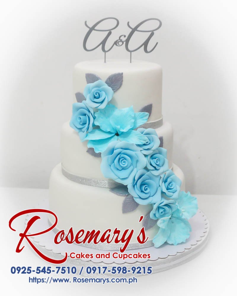 Three-tier blue, white and silver wedding cake with a stunning 3D printed topper. Order yours from Rosemary's Cakes! Call 0917-598-9215.