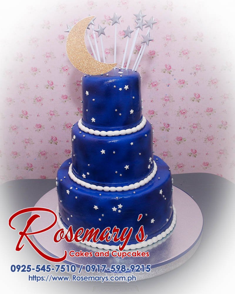 Three-layer blue and silver stars and moon themed cake, perfect for celebrations. Order from Rosemary's Cakes: 0917-598-9215.