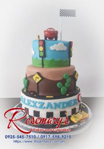 Delicious 3-layer chocolate cake decorated with fondant race cars and a Lightning McQueen topper. Order your custom cakes from Rosemary's Cakes! Call 0917-598-9215.