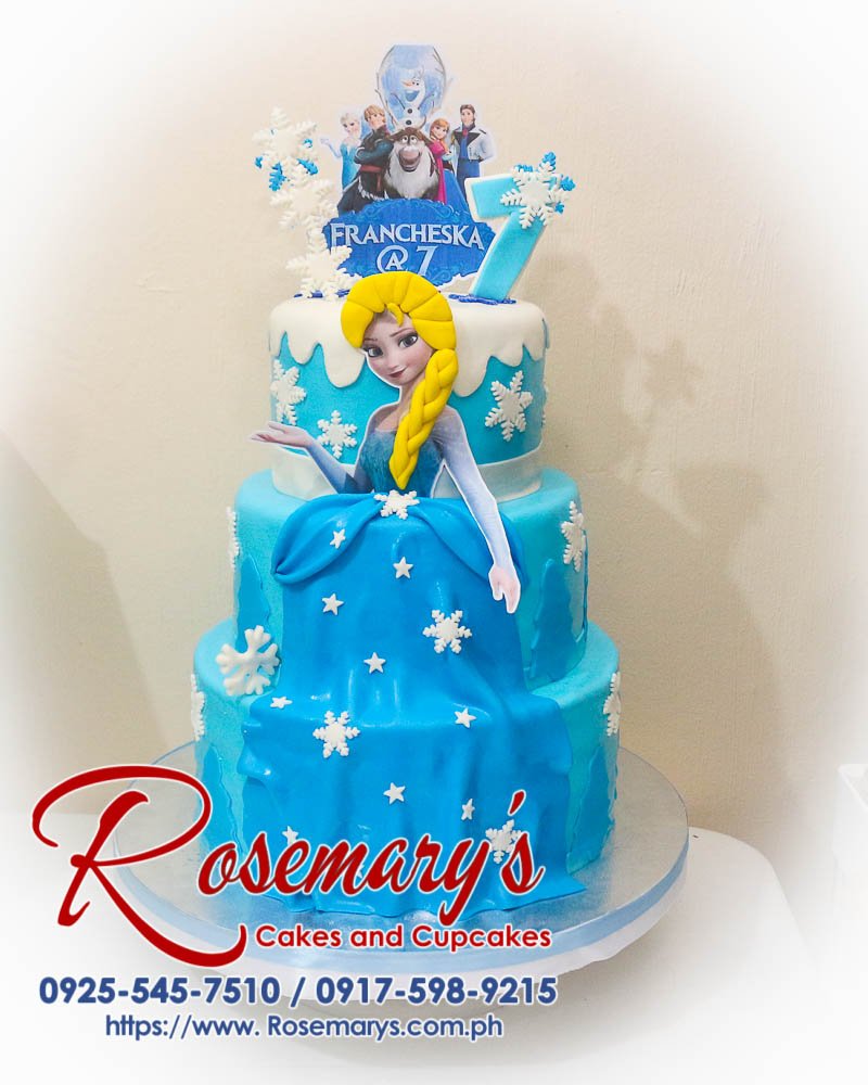 Delicious 3 layer blue Frozen themed cake adorned with Elsa for a magical celebration. Order at Rosemary's Cakes: 0917-598-9215.