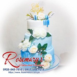 Elegant three-layer gold and blue rose drip wedding cake by Rosemary's Cakes. Perfect for Mr. and Mrs. celebrations. Contact: 0917-598-9215.