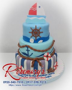 Three-tier blue cake with intricate marine-themed decorations. Perfect for any ocean lover's celebration! Rosemary's Cakes | 0925-545-7510