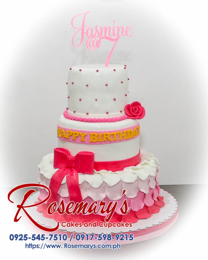 Three-layer pink and white themed cake adorned with a ribbon, crafted by Rosemary's Cakes. Contact 0917-598-9215.