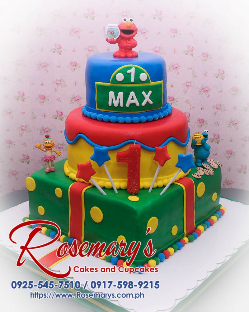 3 Layer Sesame Street Themed Cake for Max Delicious 3 layer Sesame Street themed cake featuring Cookie Monster and Elmo, vibrant blue, green, and red. Rosemary's Cakes, 0925-545-7510.