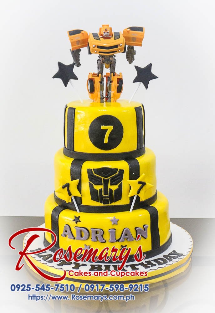 Three-tier yellow cake decorated with black fondant and a Transformers Bumblebee theme. Order your custom cakes from Rosemary's Cakes: 0917-598-9215.