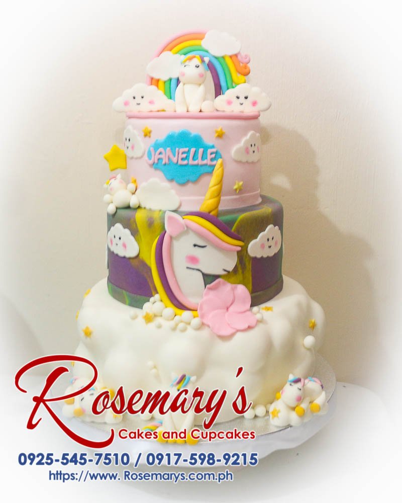 Three-layer unicorn-themed cake with pastel rainbow colors, featuring whimsical decorations. Order from Rosemary's Cakes at 0917-598-9215.