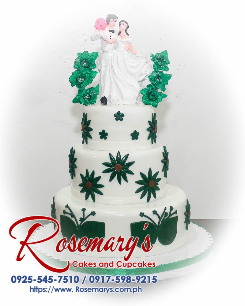 Stunning 3 layer white and green wedding cake by Rosemary's Cakes, featuring elegant floral accents. Call 0917-598-9215.
