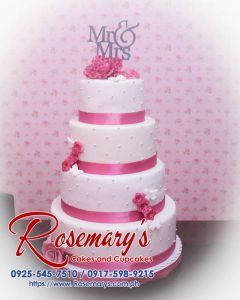 Four-layer white and pink wedding cake adorned with delicate roses and a 3D printed topper. Order from Rosemary's Cakes: 0917-598-9215.