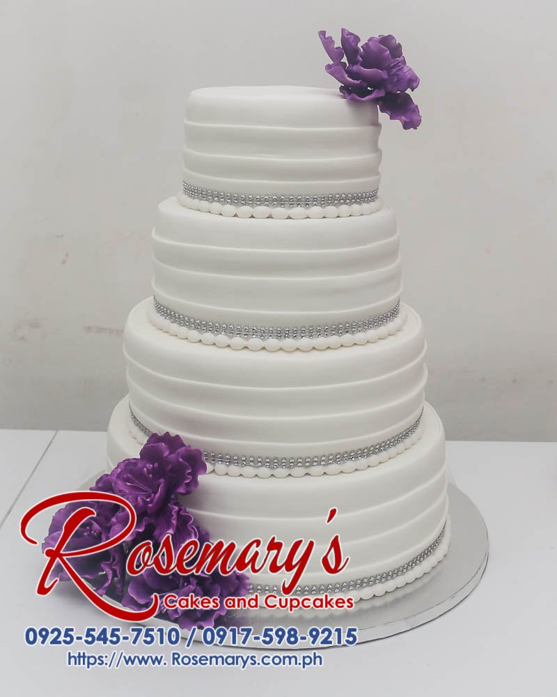 4 Layer White and Purple Wedding Cake-2 Four-layer white wedding cake with cascading purple floral decorations. Delicious and elegant for your special day! Rosemary's Cakes: 0925-545-7510
