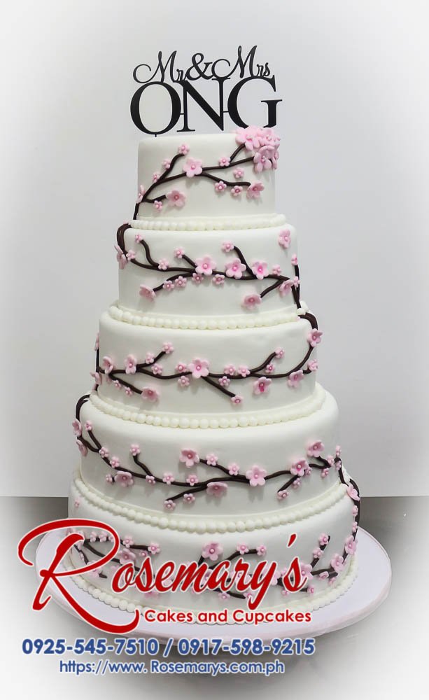 Stunning 5-tier wedding cake with a unique 3D printed topper. Featuring delicate pink and white layers for a romantic touch. Rosemary's Cakes: 0917-598-9215