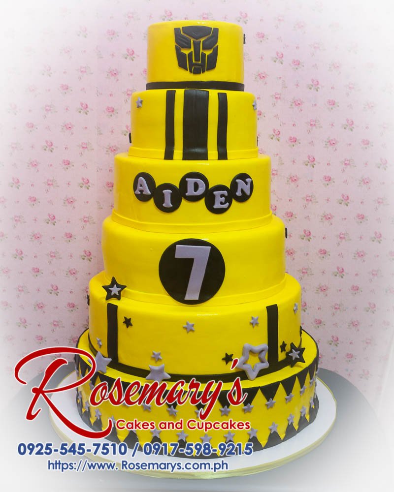 Delicious 6 layer Transformers-themed cake featuring autobots in black and yellow. Order from Rosemary's Cakes at 0917-598-9215.