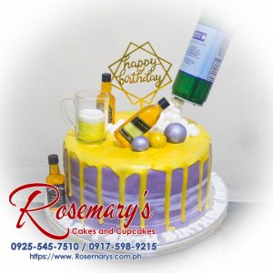 Delicious booze-themed drip cake with colorful toppings, perfect for wedding anniversaries. Order at Rosemary's Cakes: 0917-598-9215.