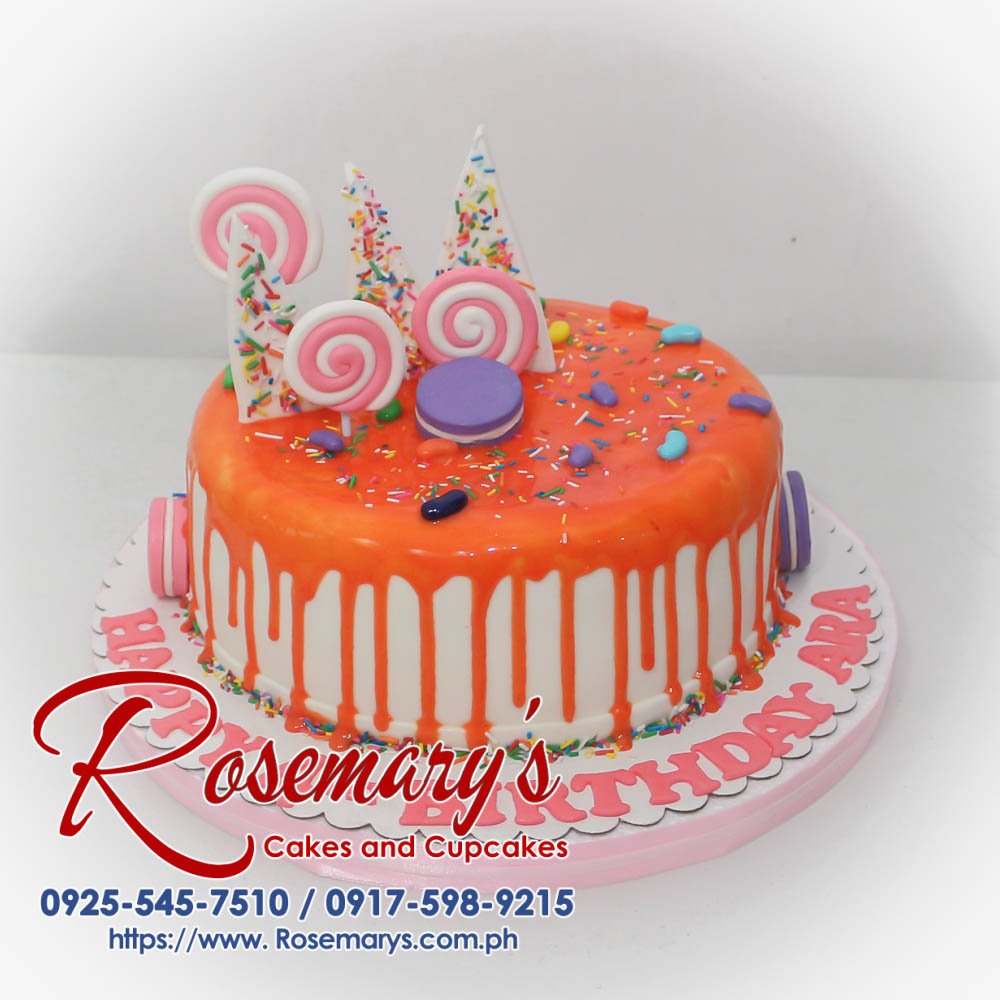Delicious one-layer pink Candyland themed cake adorned with colorful candies and whimsical decorations. Rosemary's Cakes | 0917-598-9215