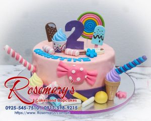 Candyland themed 1 layer pink cake from Rosemary's Cakes, featuring colorful candies and vibrant decorations. Contact 0917-598-9215.