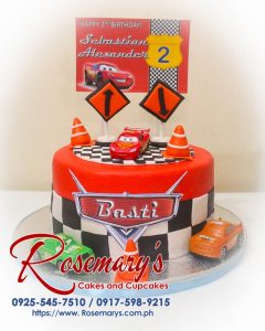 Delicious one-layer Cars themed cake in vibrant red, perfect for birthdays. From Rosemary's Cakes, contact 0925-545-7510.